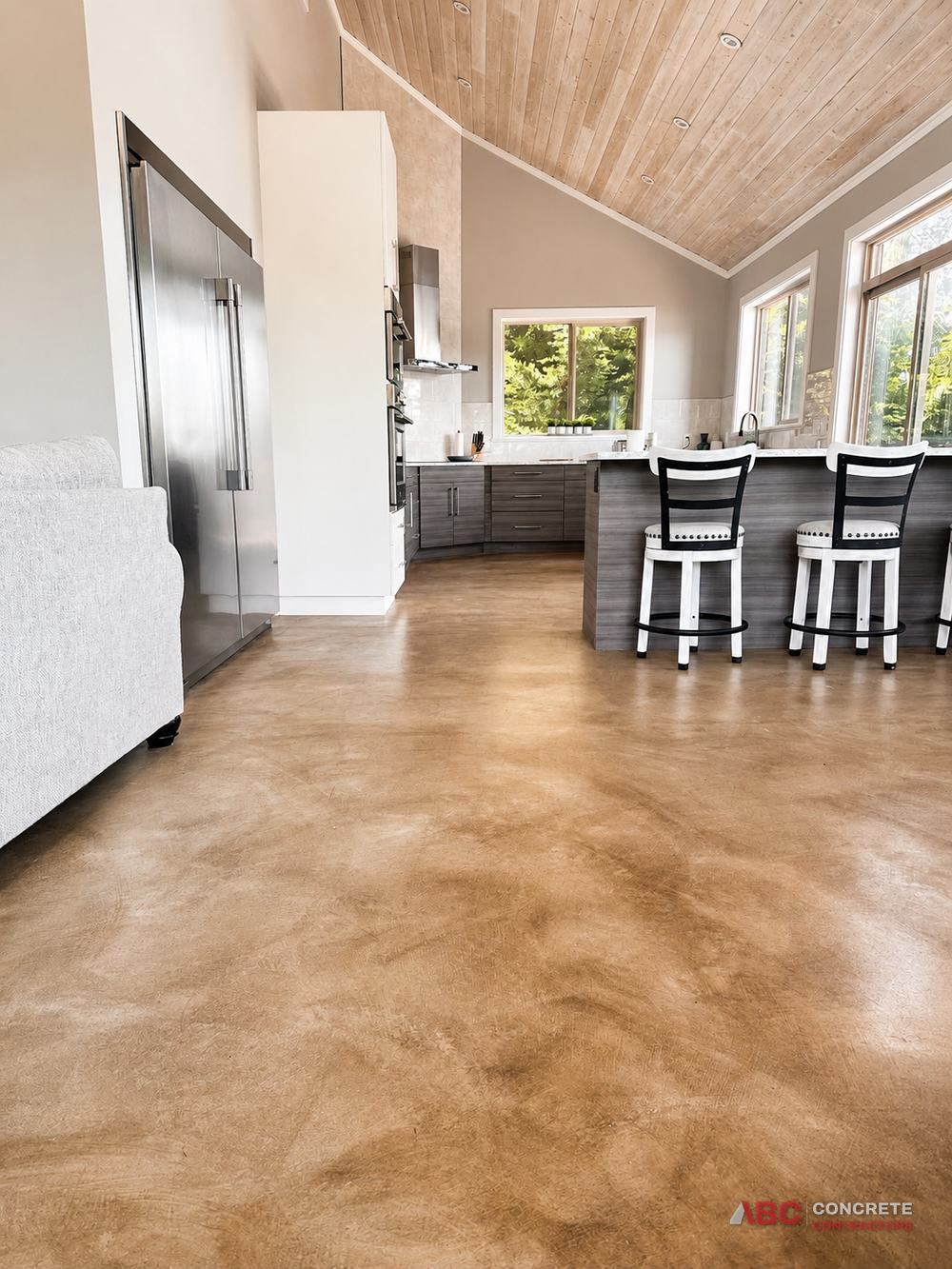 Interior stained and sealed concrete floor in an open plan kitchen and living area
